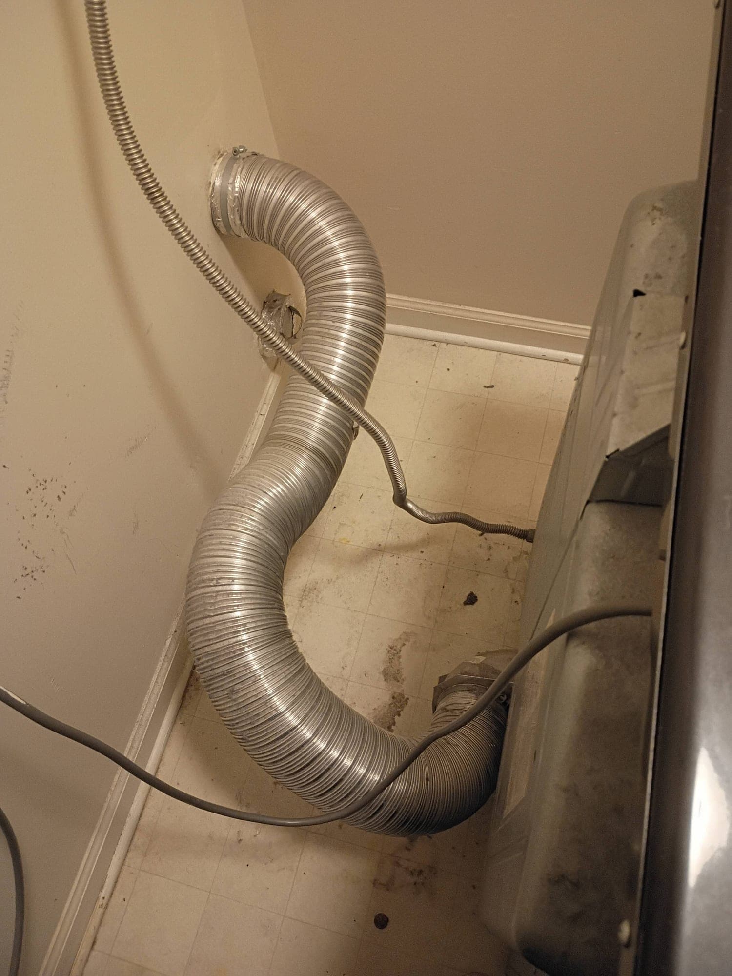 Flexible ducting connected to a wall vent during air duct cleaning service